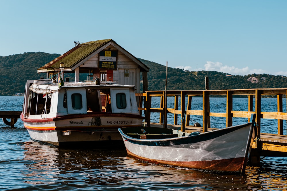 two boats docked at a pier with a house on it
