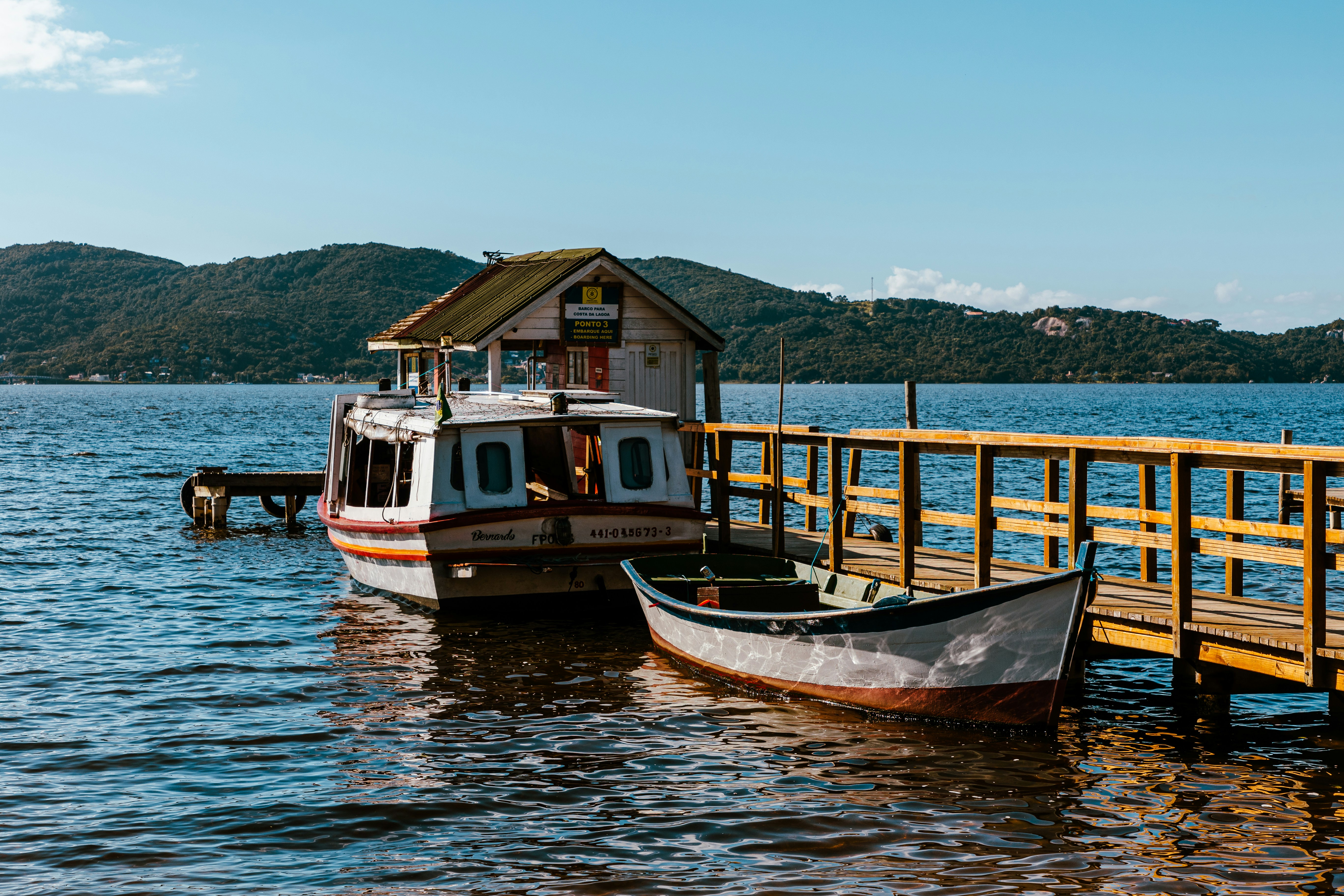 a boat docked at a pier with a house on it