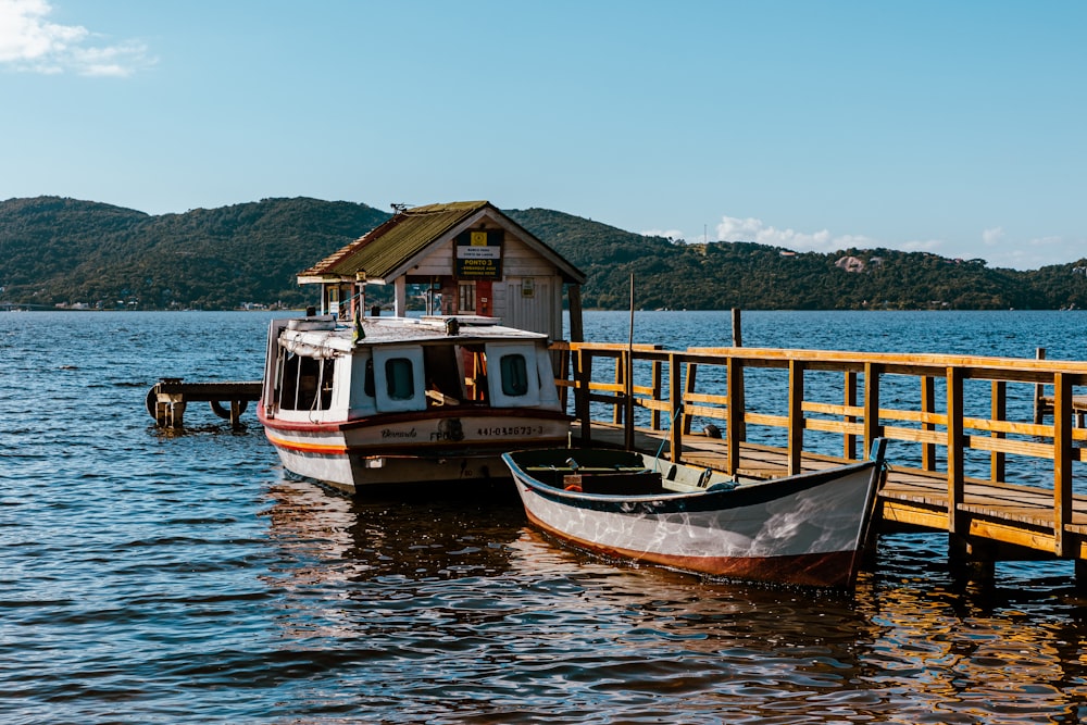 a boat docked at a pier with a house on it