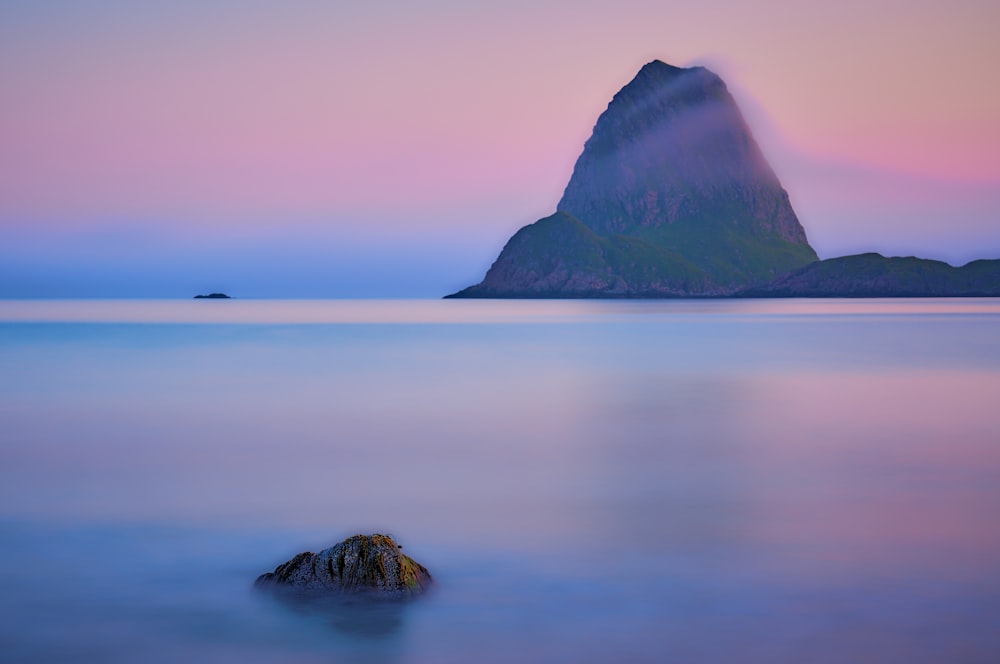 a mountain in the middle of a body of water