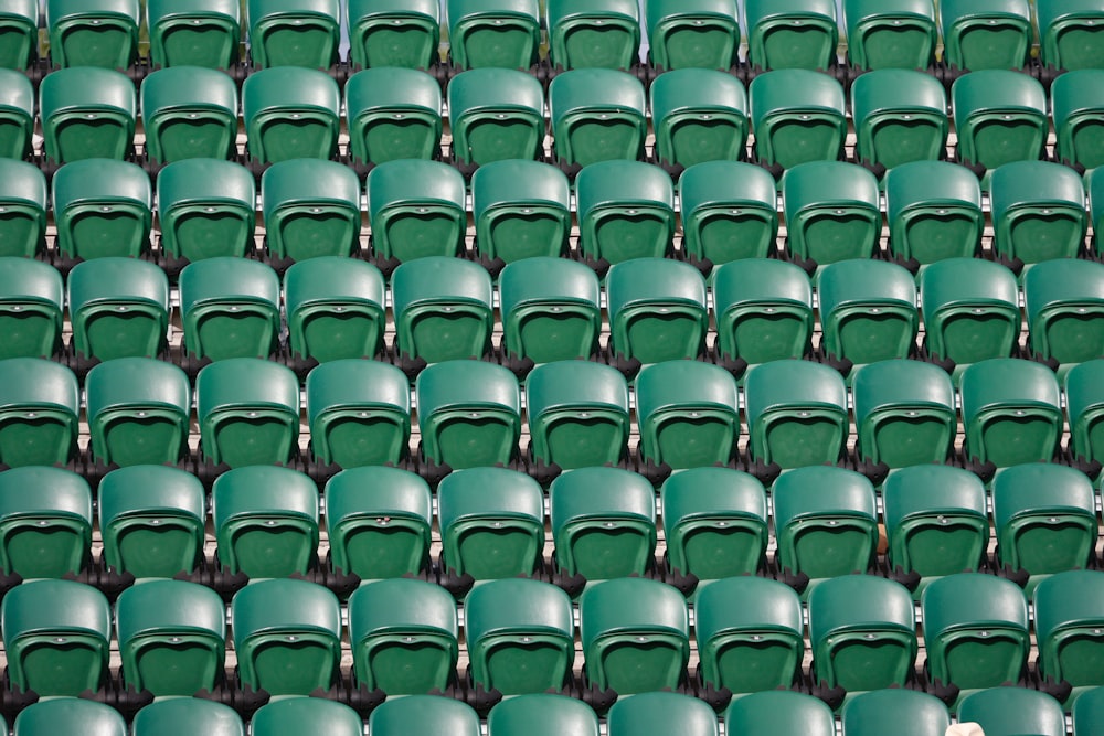 a row of green seats in a stadium