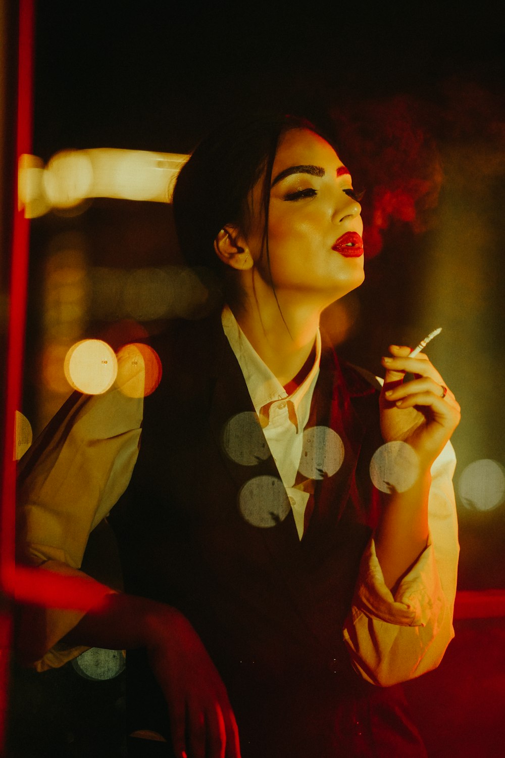 a woman smoking a cigarette in the dark