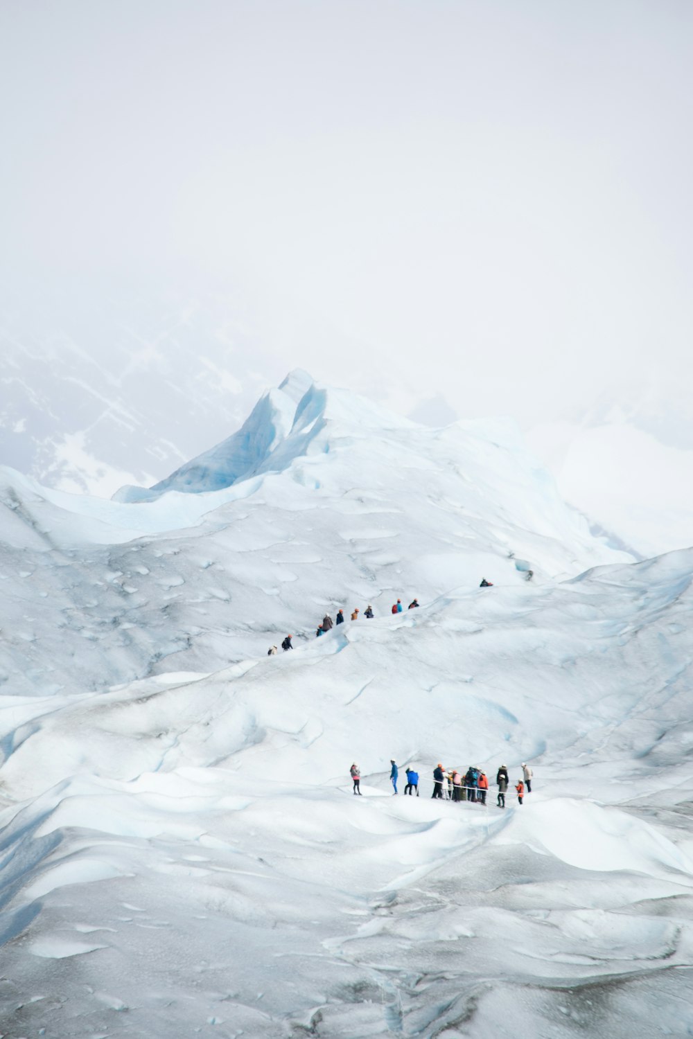 a group of people standing on top of a snow covered slope