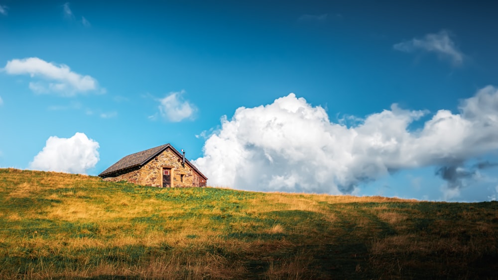 a house sitting on top of a lush green hillside