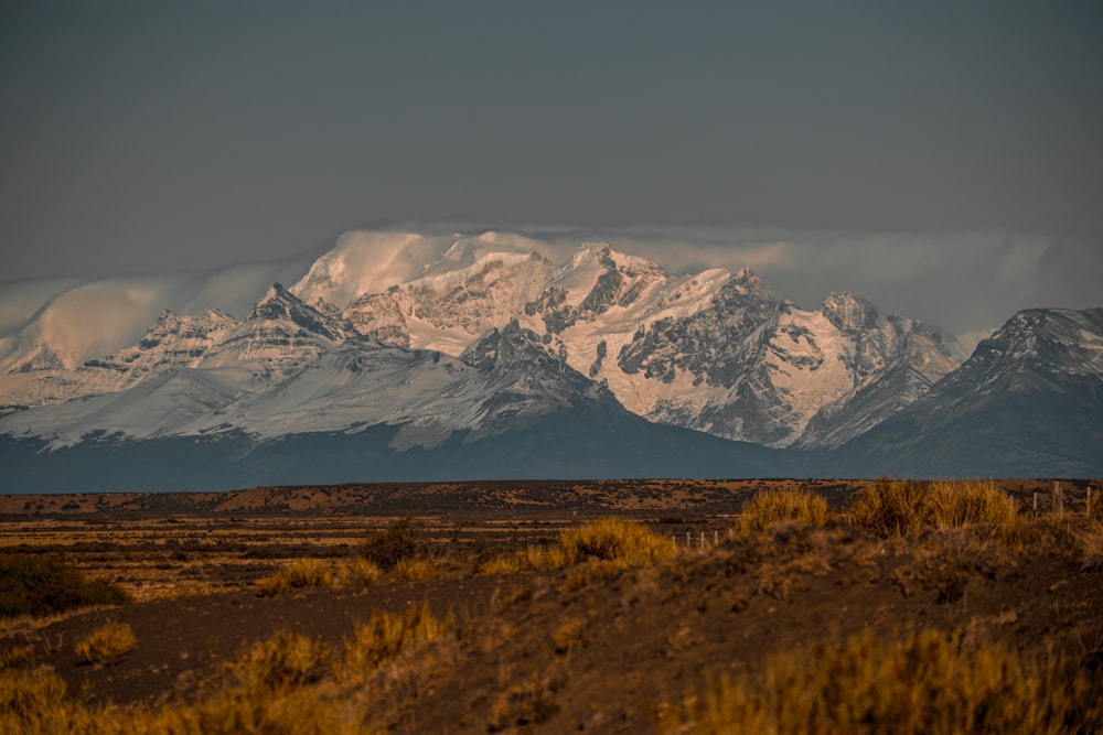 a snow covered mountain range in the distance