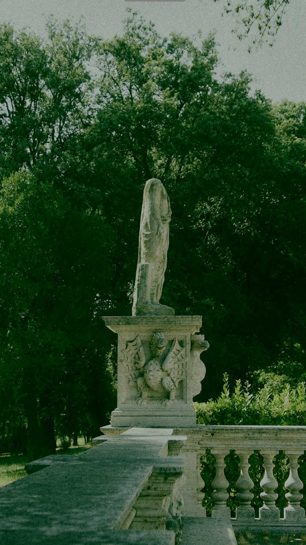 a statue of a woman is in a park