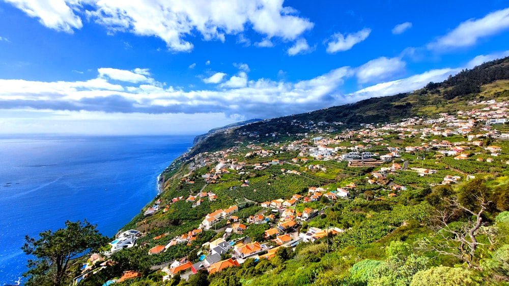 a scenic view of a small town on the side of a mountain