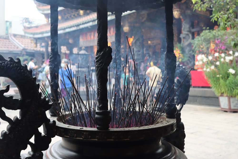 a close up of a metal object with sticks sticking out of it