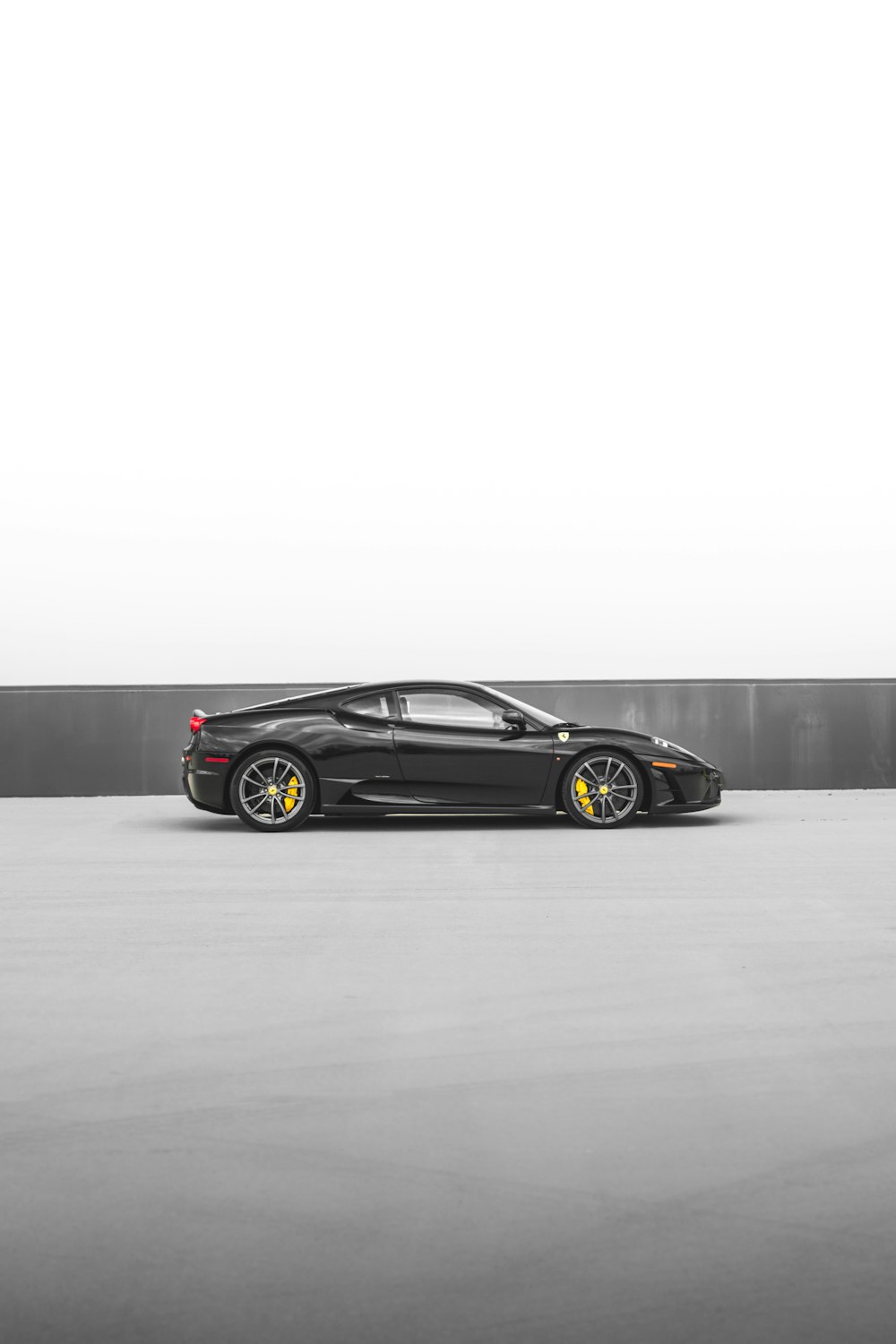 a black sports car parked in a parking lot