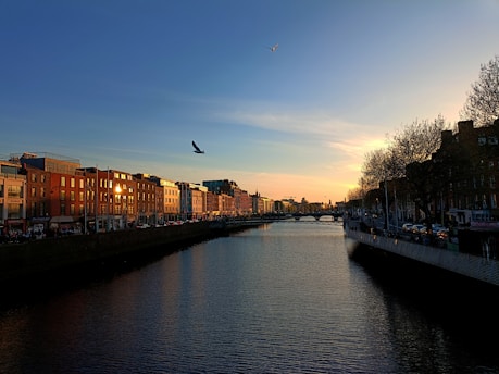 a river running through a city next to tall buildings