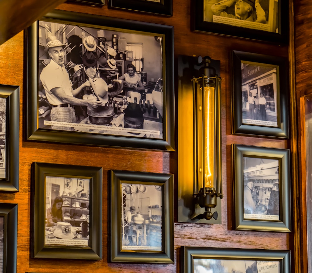 a bunch of framed pictures on a wall