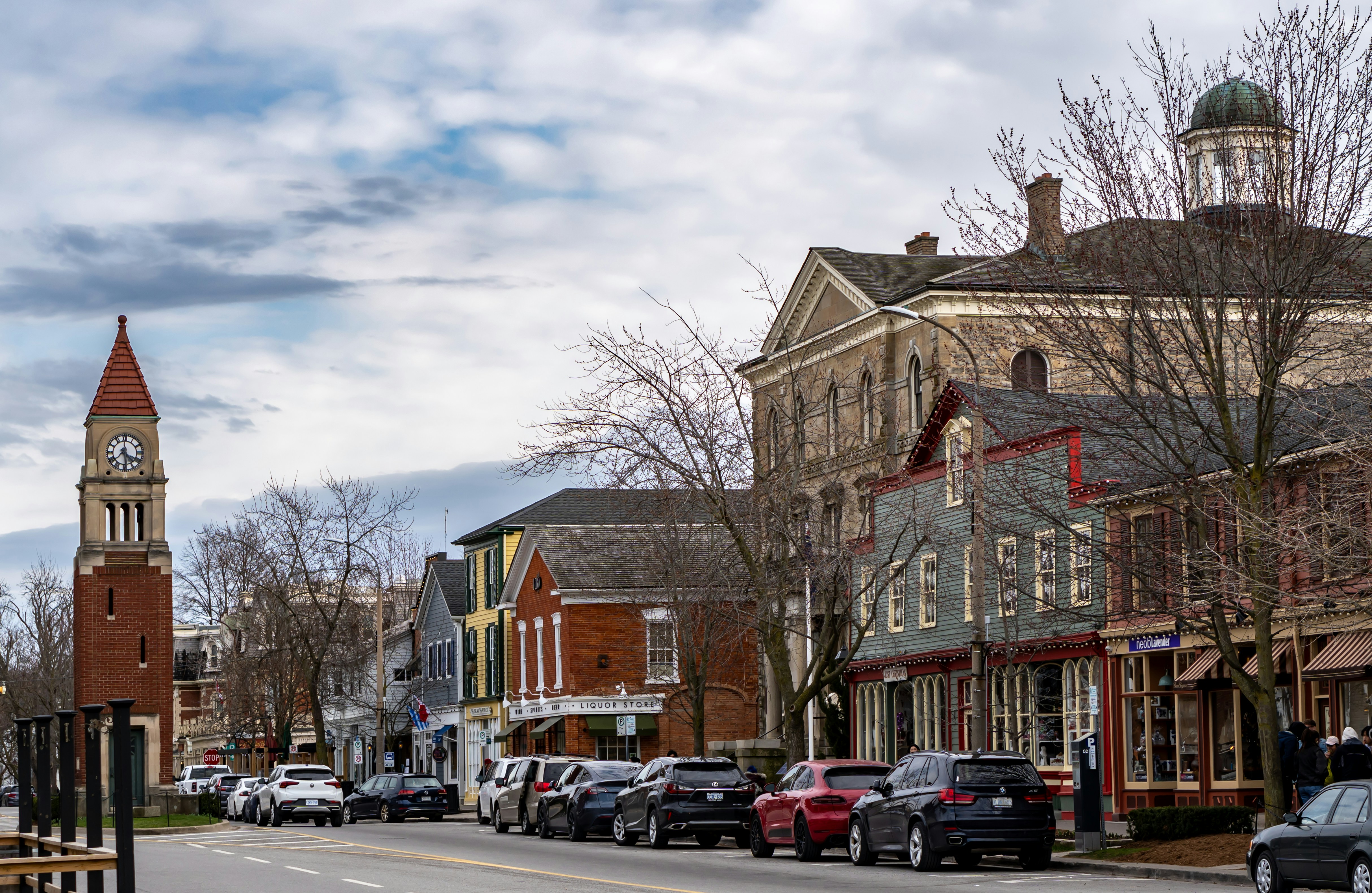 a city street with a clock tower in the background