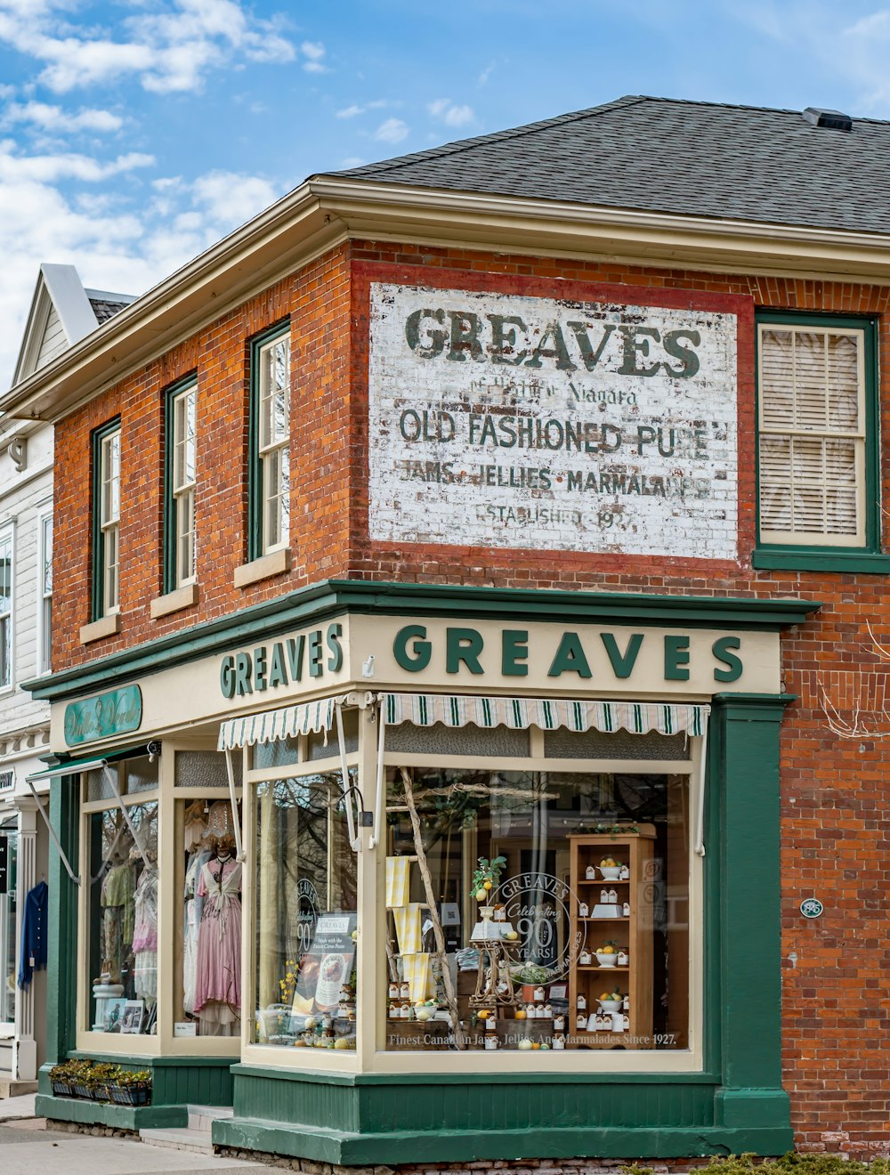 an old fashion store on the corner of a street