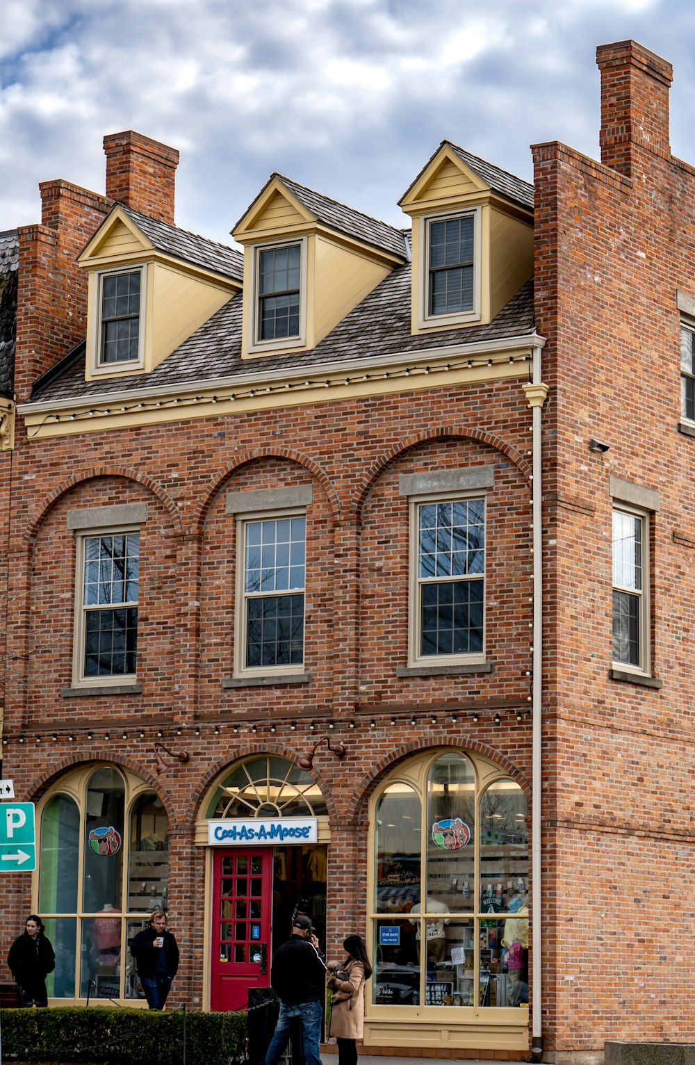 a group of people standing outside of a brick building