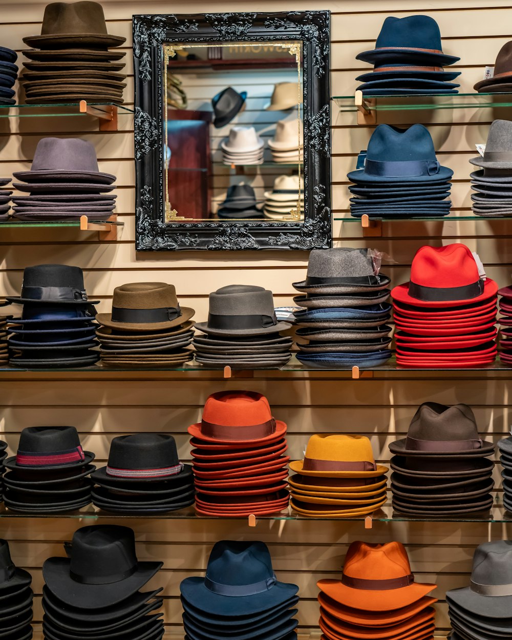 a wall of hats and a mirror in a store