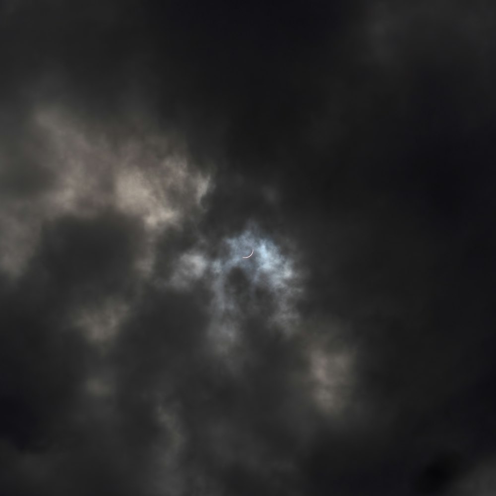 a plane flying through a dark cloudy sky