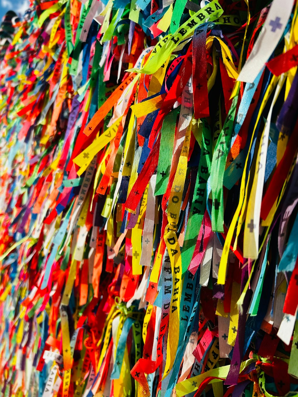 a wall covered in colorful streamers of ribbons