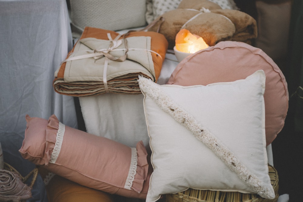 a pile of pillows and pillows sitting on top of a table