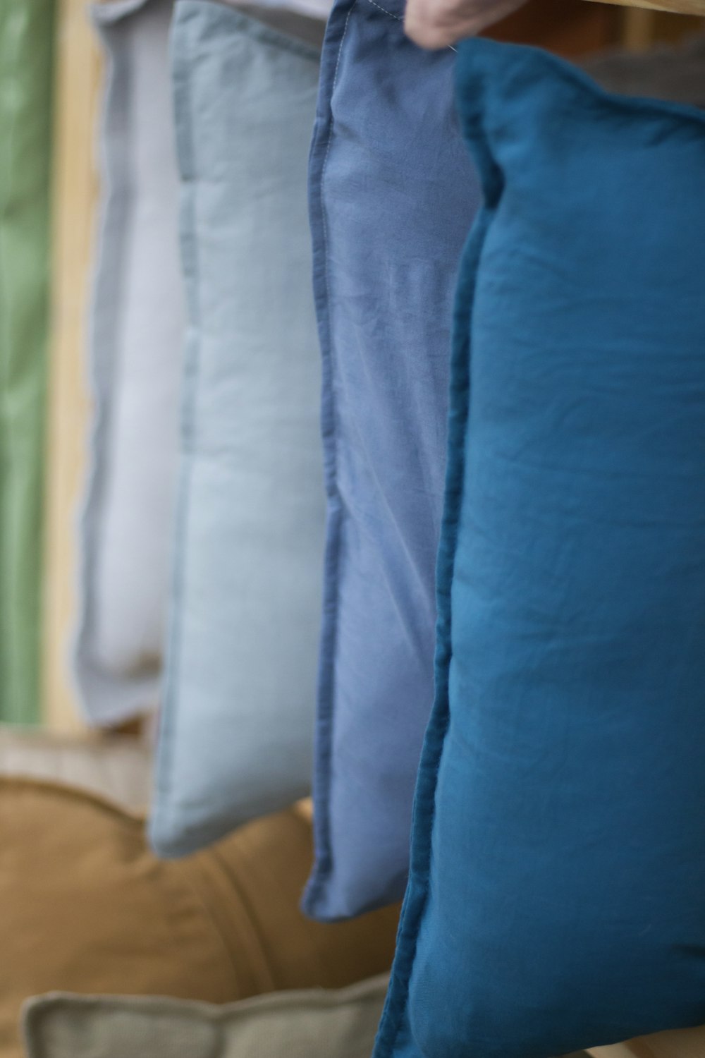 a row of pillows hanging on a wall