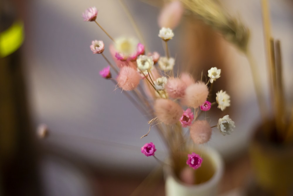 a vase filled with pink and white flowers