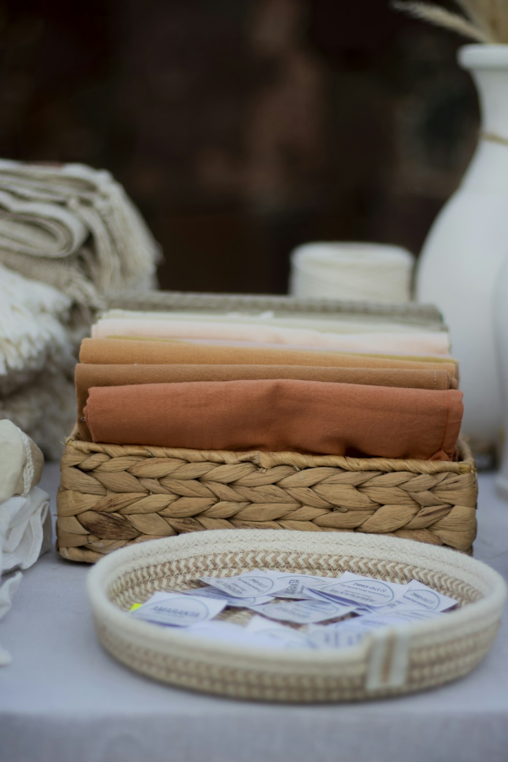 a table topped with a basket filled with cloth