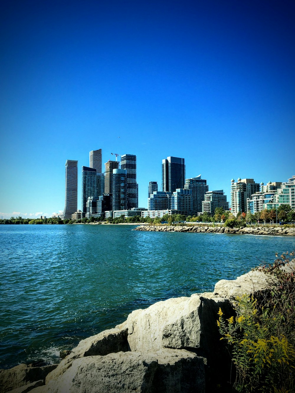 a large body of water with a city in the background