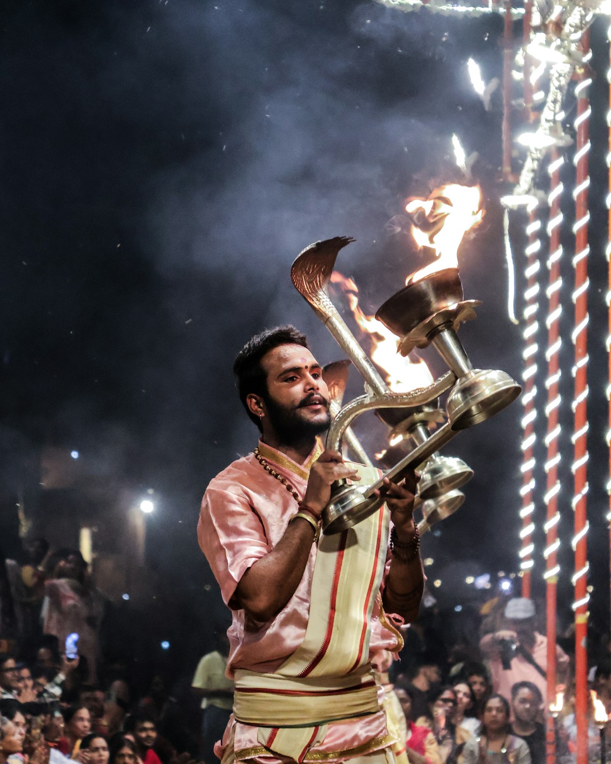 Priest performing the evening Ganga Aarti ceremony at a Varanasi ghat