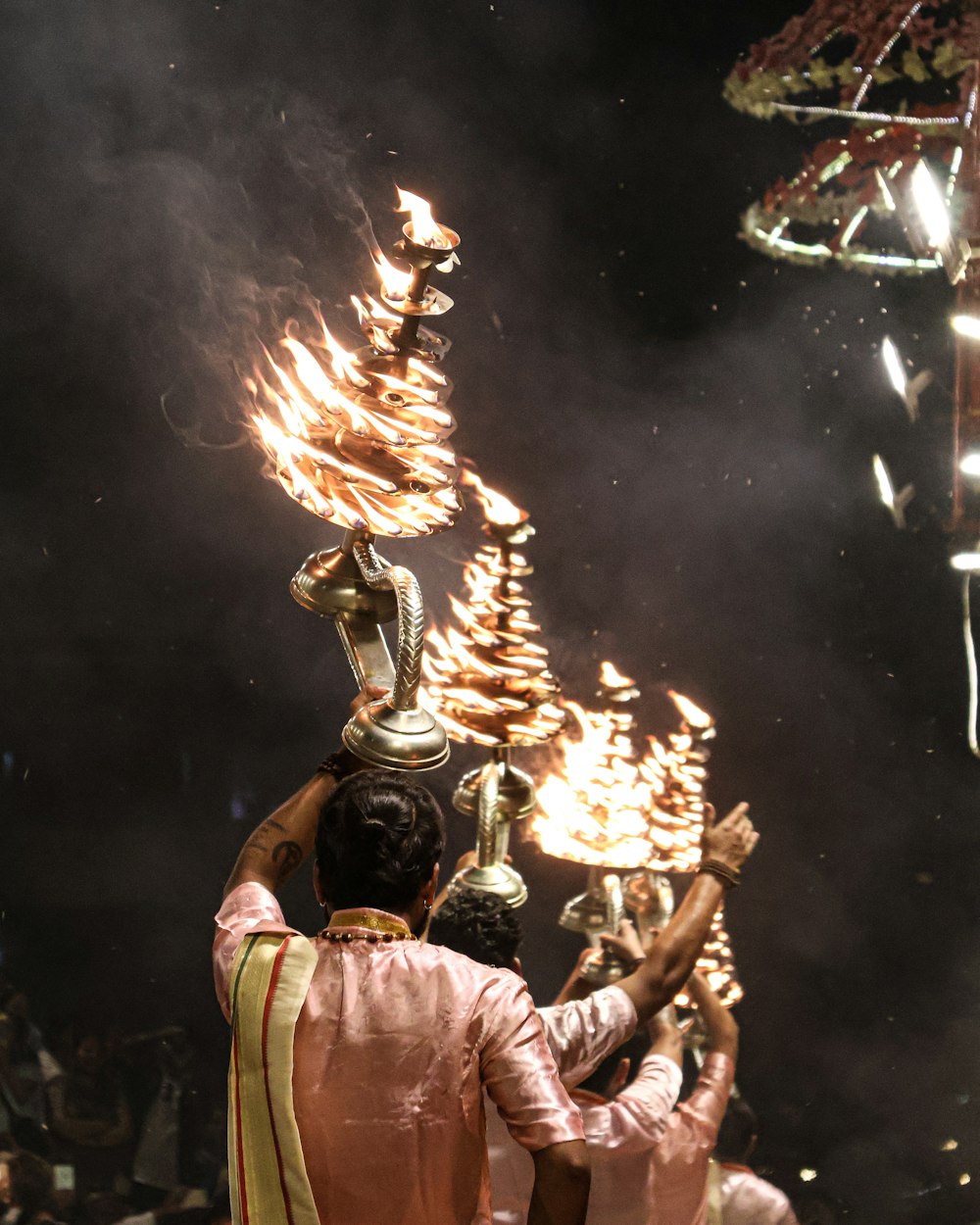 a couple of people that are holding torches