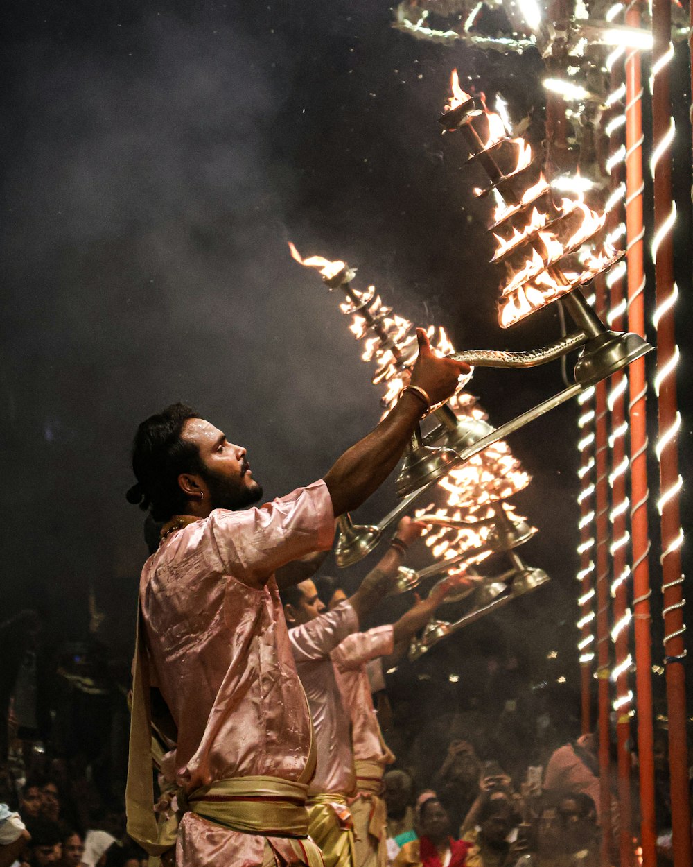 a man in a pink outfit holding a stick