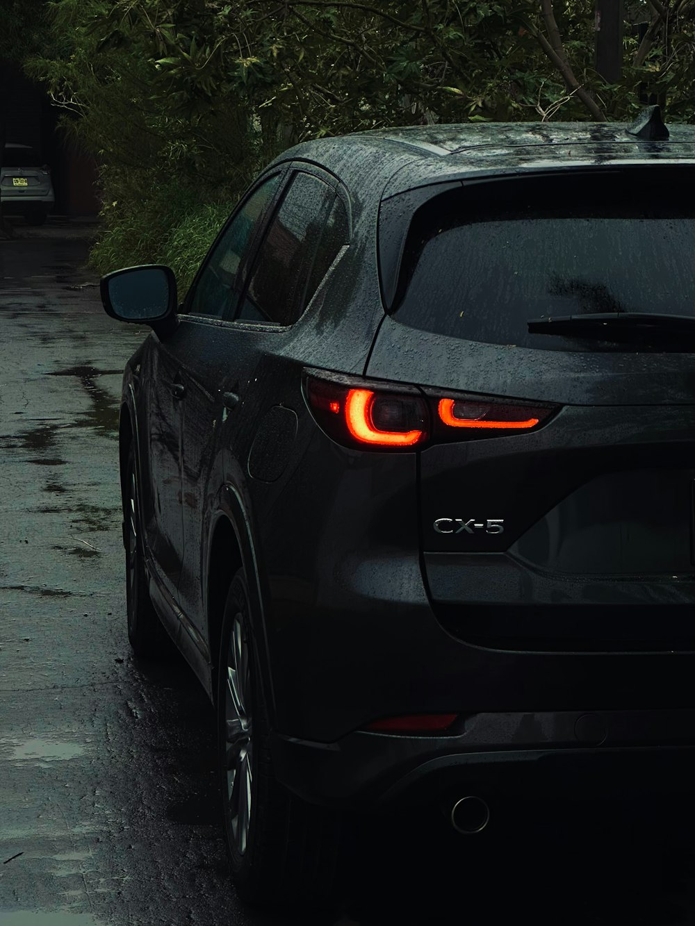 a car parked on the side of the road in the rain