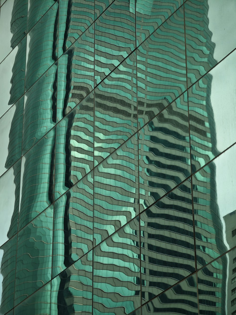 the reflection of a building in the glass of another building