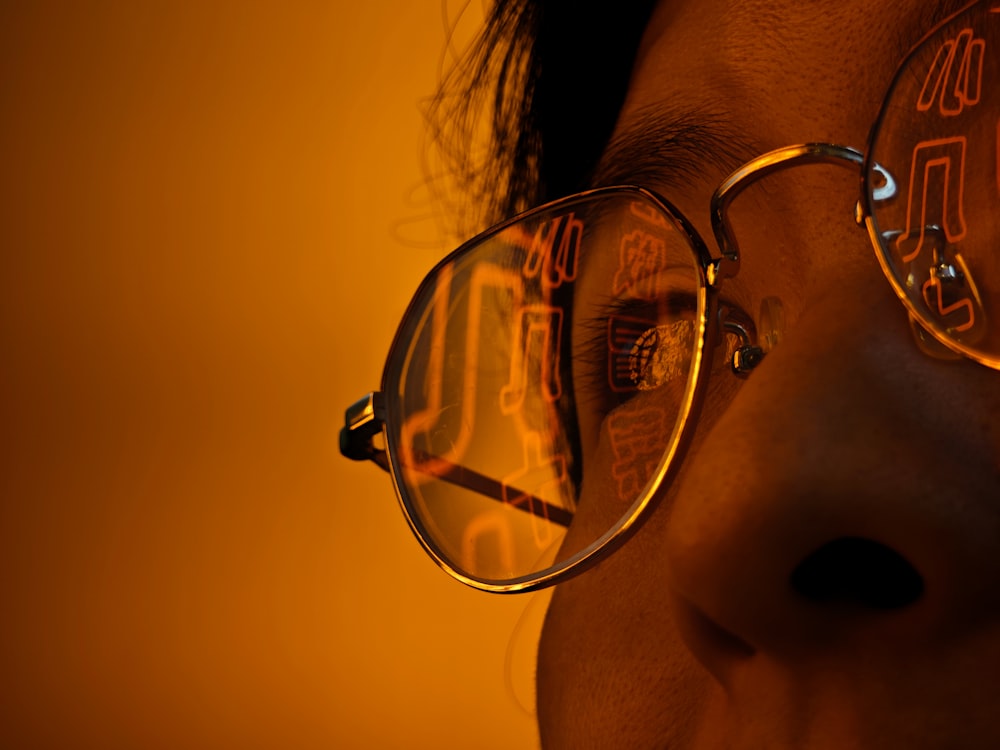 a close up of a person wearing a pair of glasses