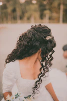 a woman in a wedding dress holding a bouquet of flowers