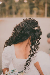 a woman in a wedding dress holding a bouquet of flowers