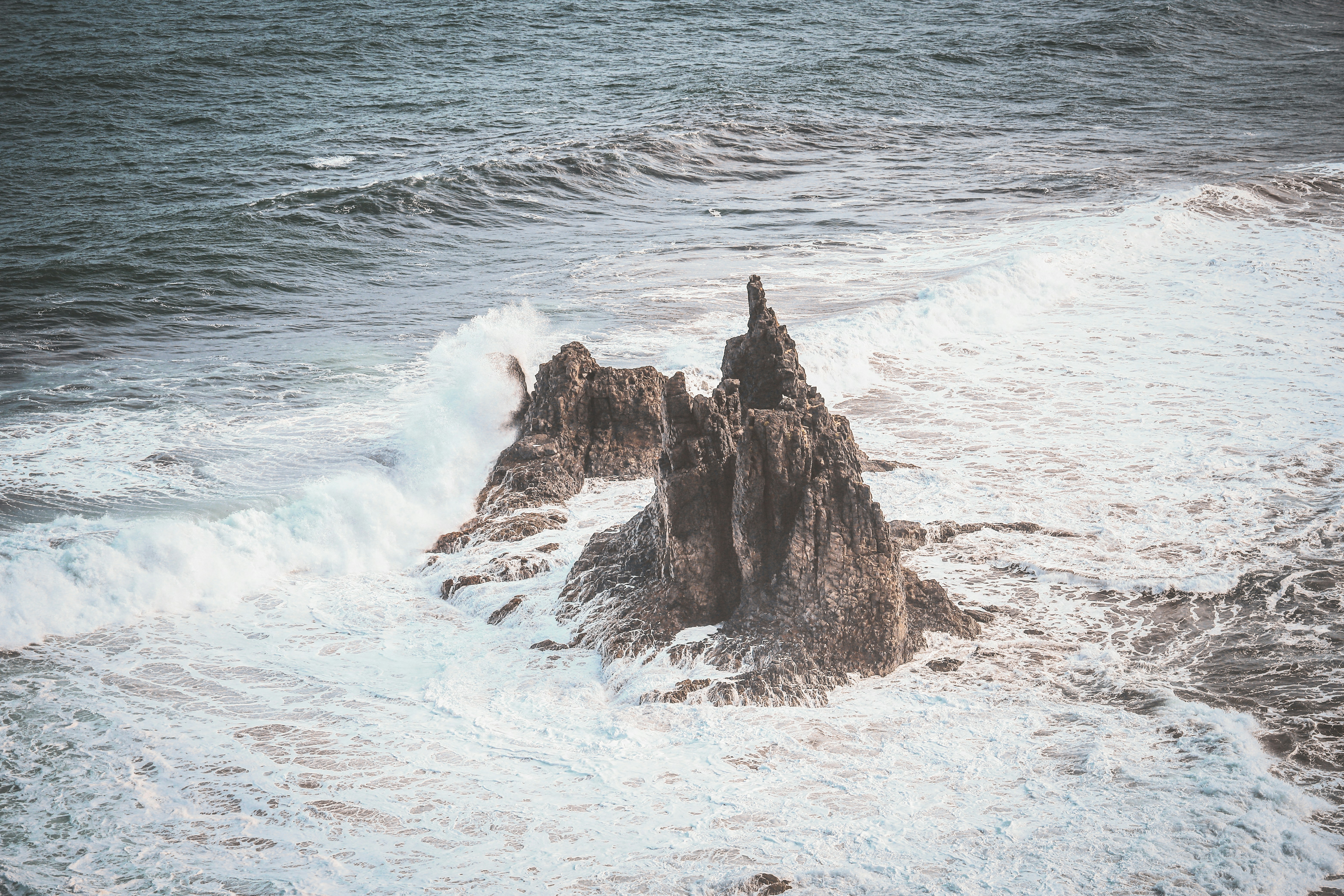 a large body of water next to a rocky shore