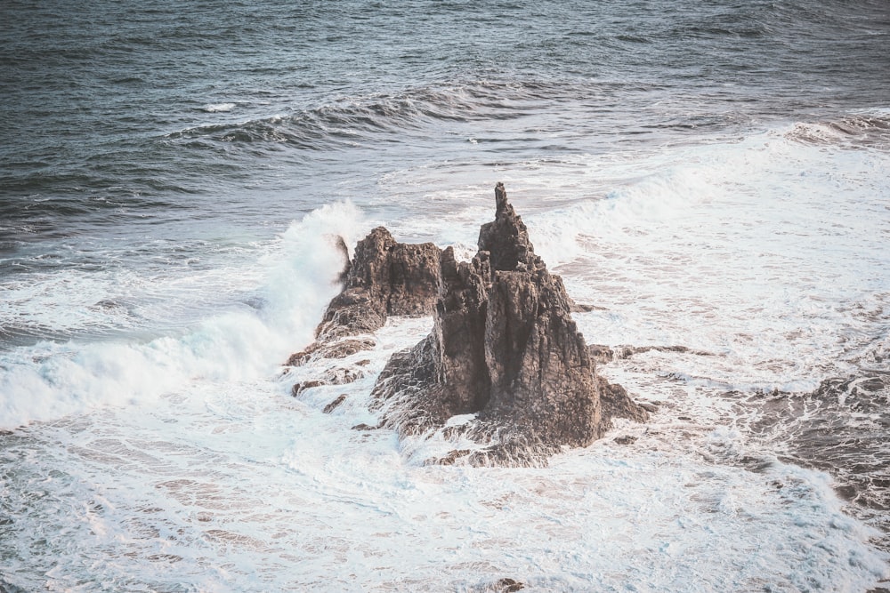 a large body of water next to a rocky shore