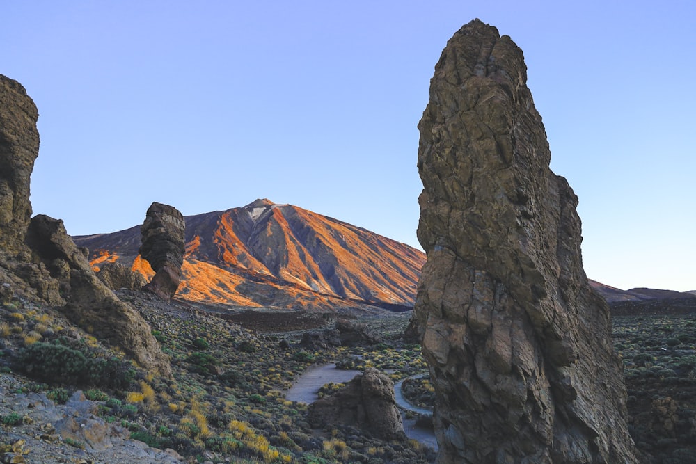 a view of a mountain from between two rocks