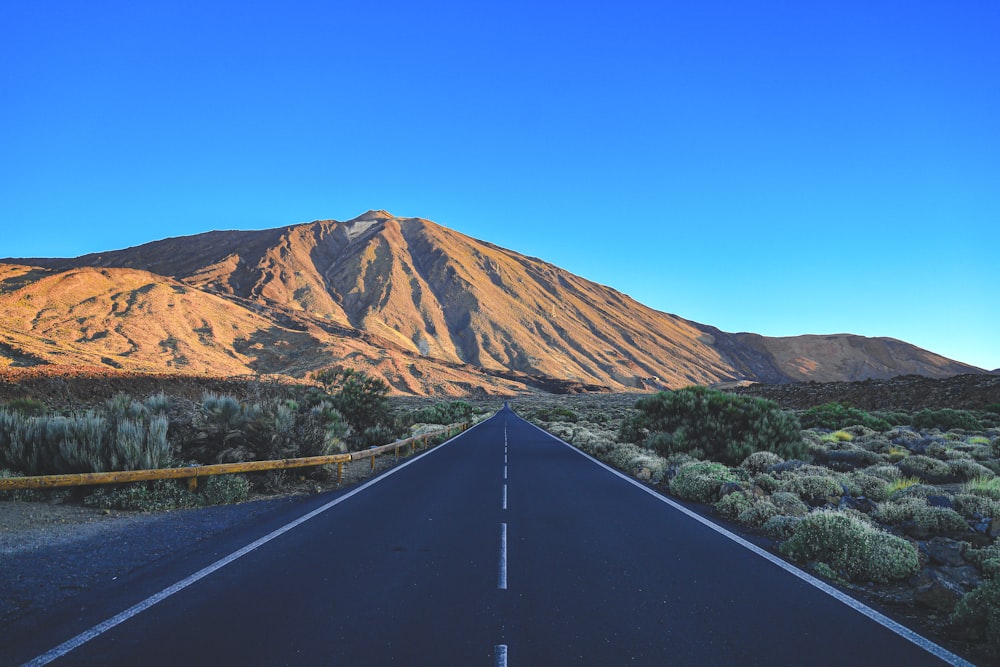 a road with a mountain in the background