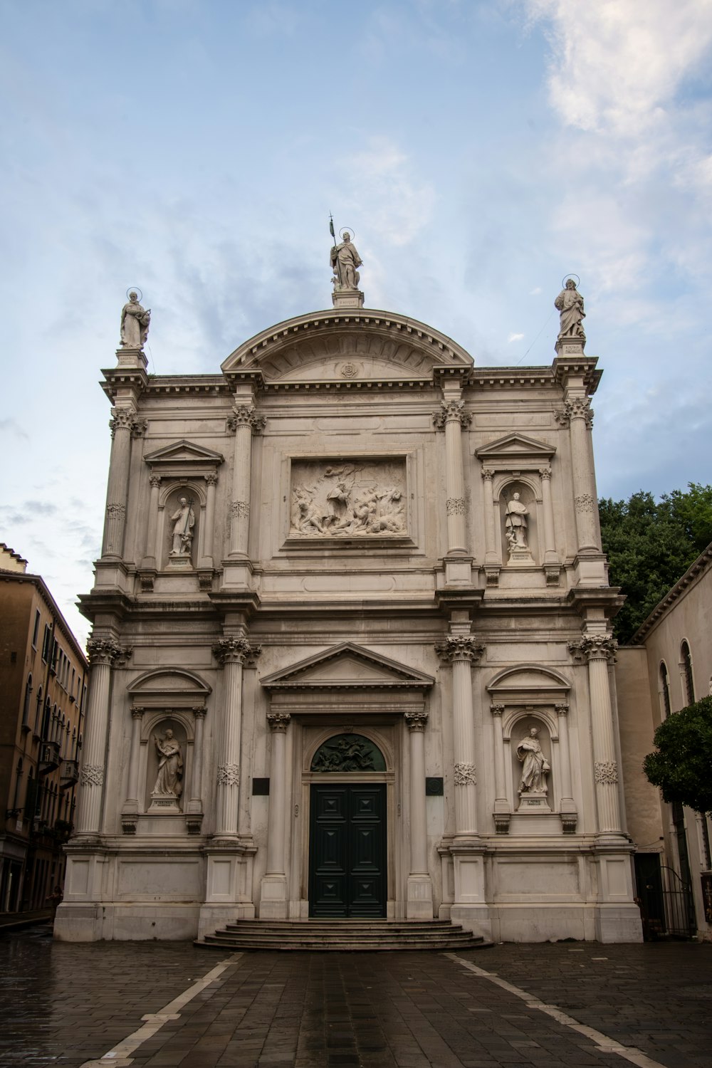 a large white building with statues on the front of it