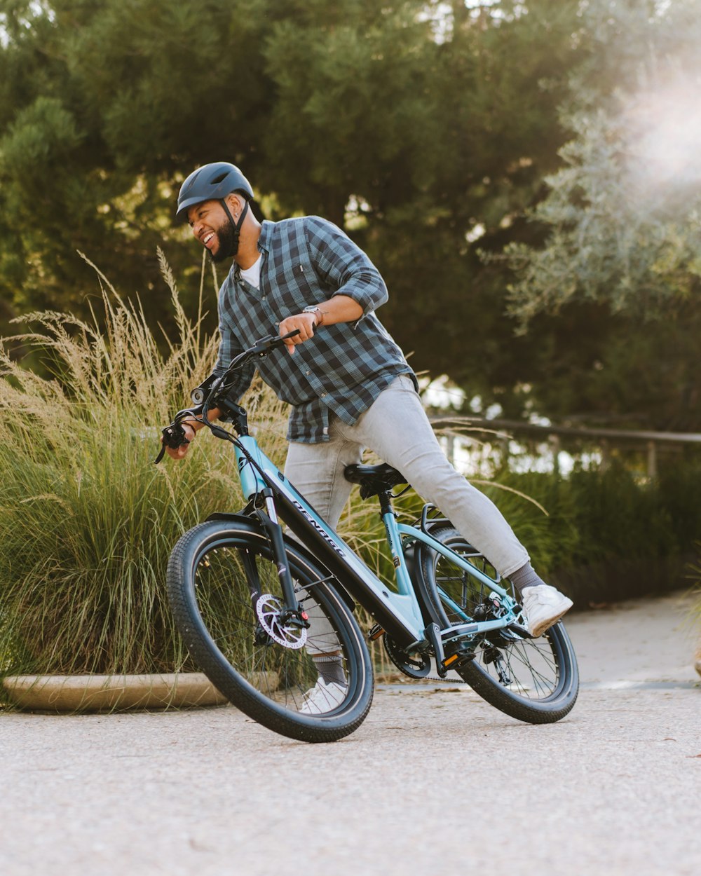 a man riding a blue bike down a street