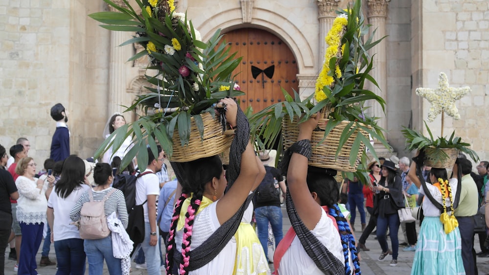 a couple of people that are holding some plants