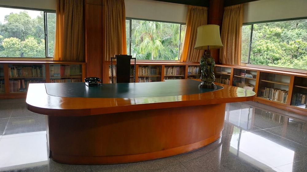 a large wooden desk in a library