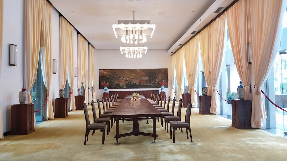 a dining room with a long table and a chandelier