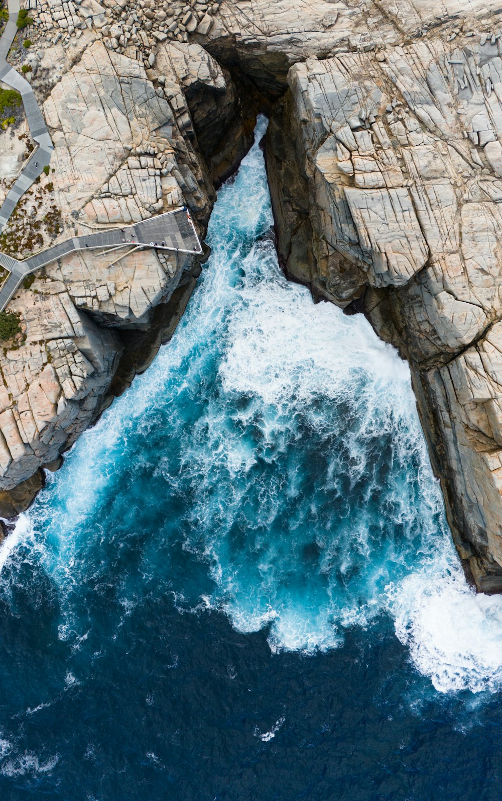 a large body of water near a rocky cliff