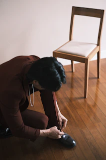 a woman kneeling down on the floor next to a chair