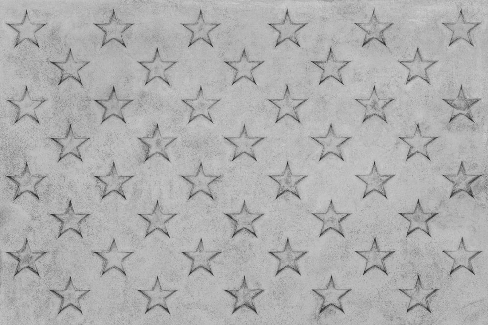 a black and white photo of stars on a wall