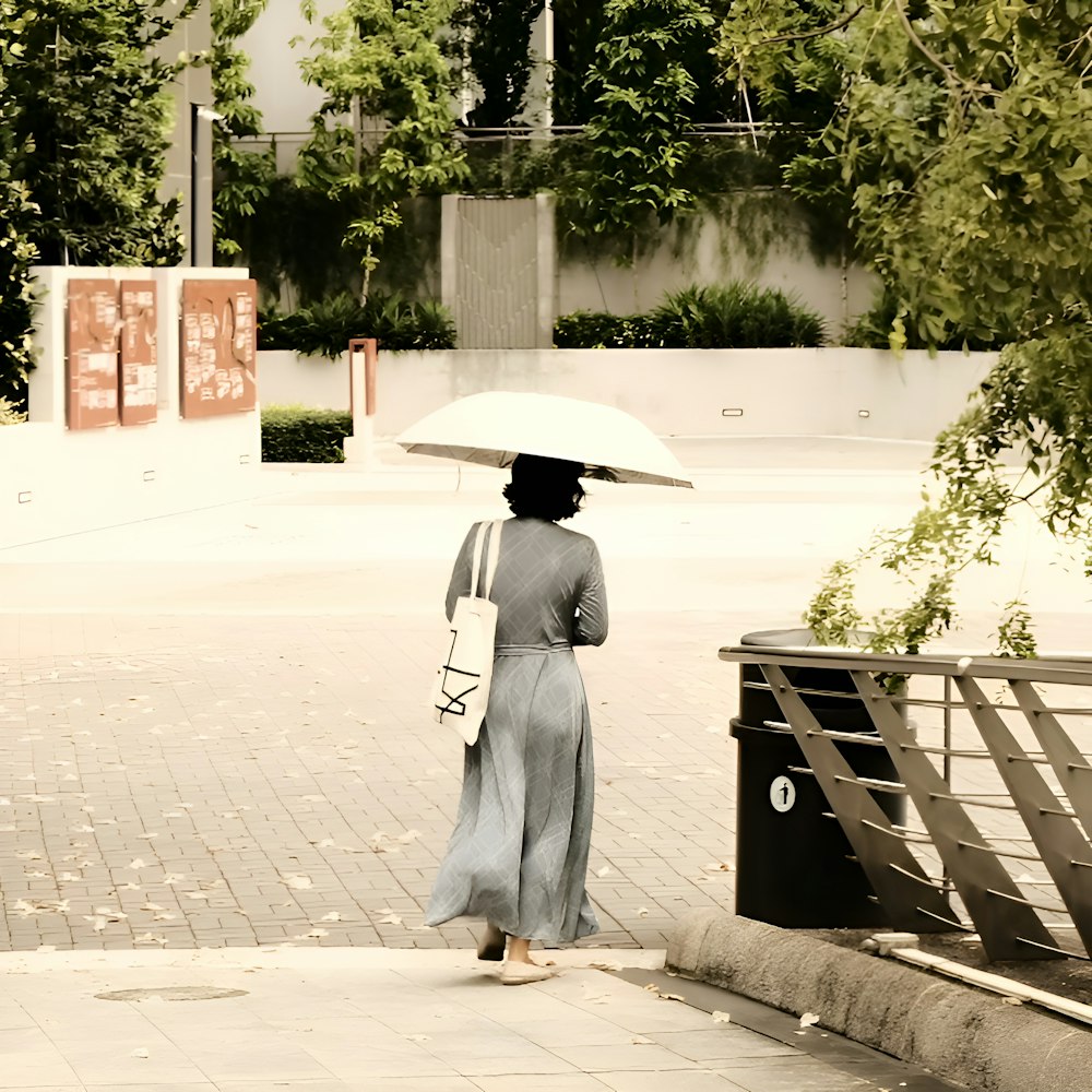 a woman walking down a street holding an umbrella