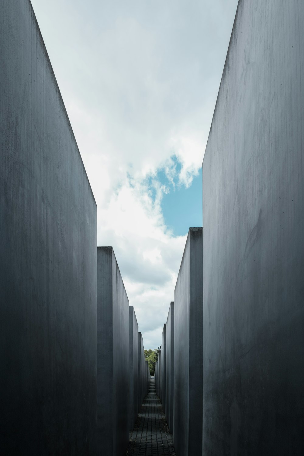 a long narrow walkway between two concrete walls