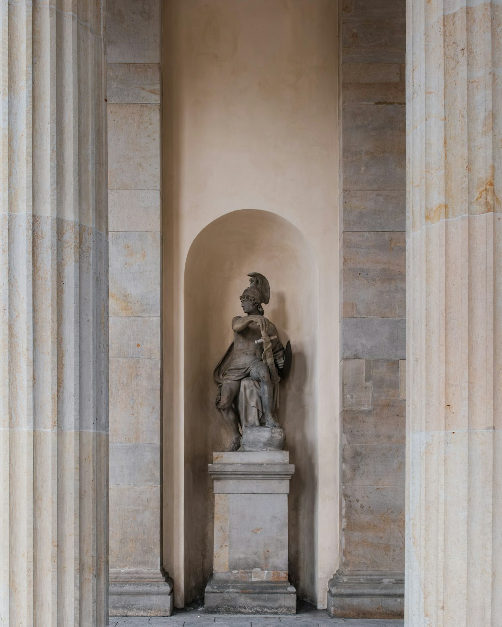 a statue of a man sitting on a pedestal
