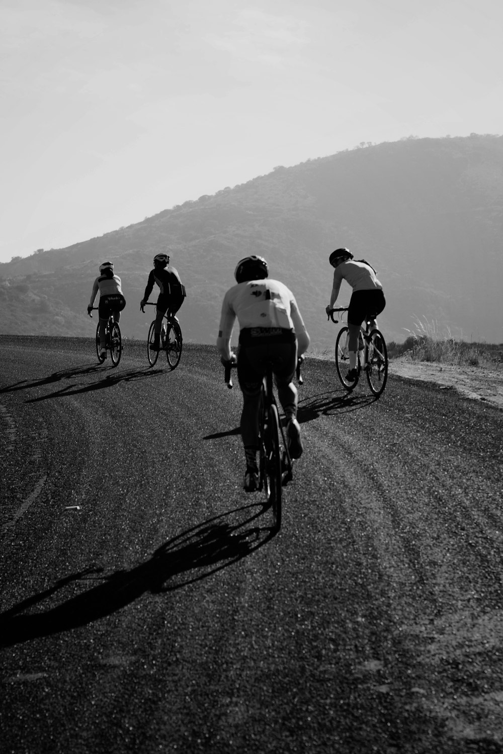 a group of people riding bikes down a road